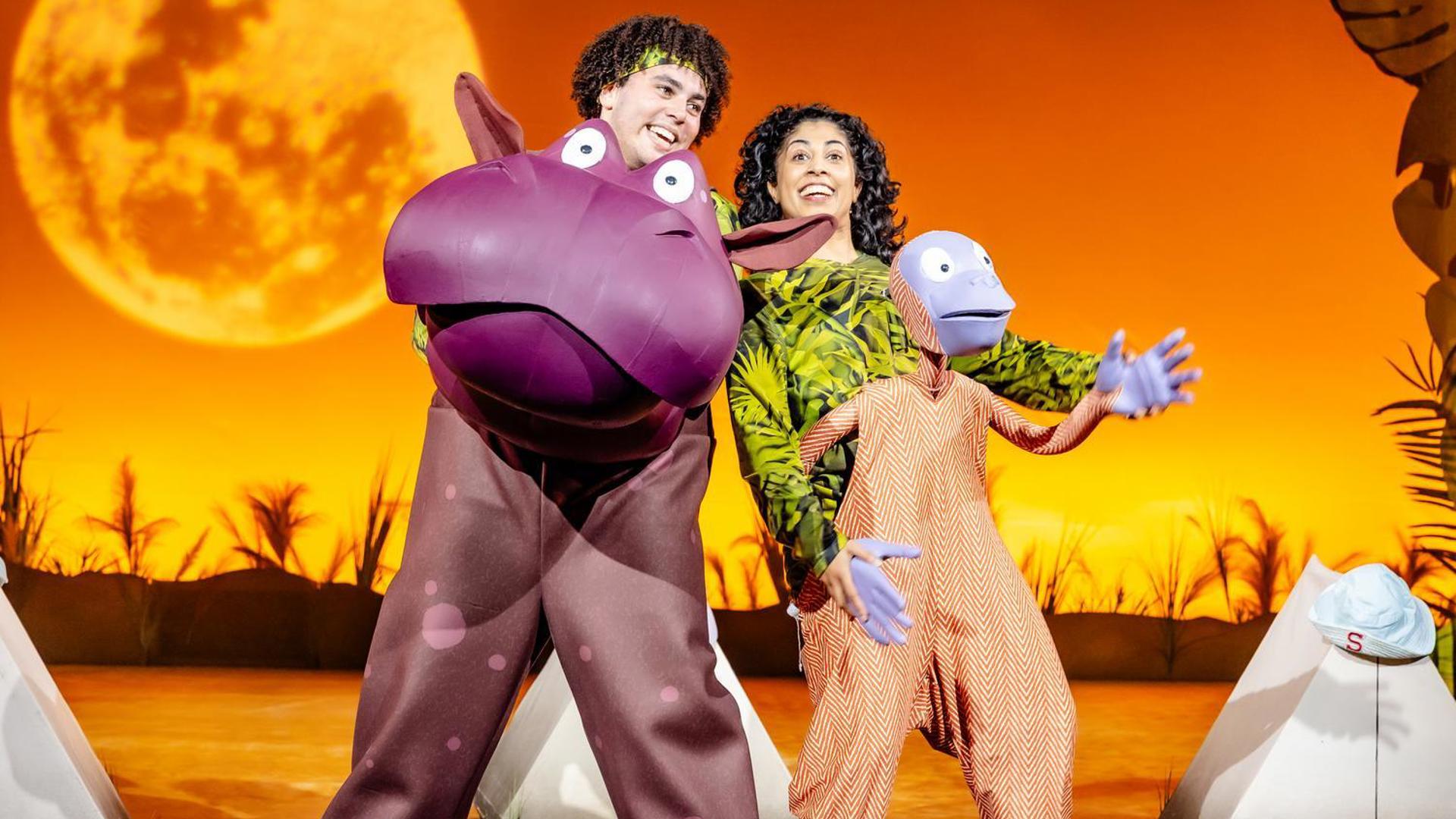 A hippo and an orangutan dancing.