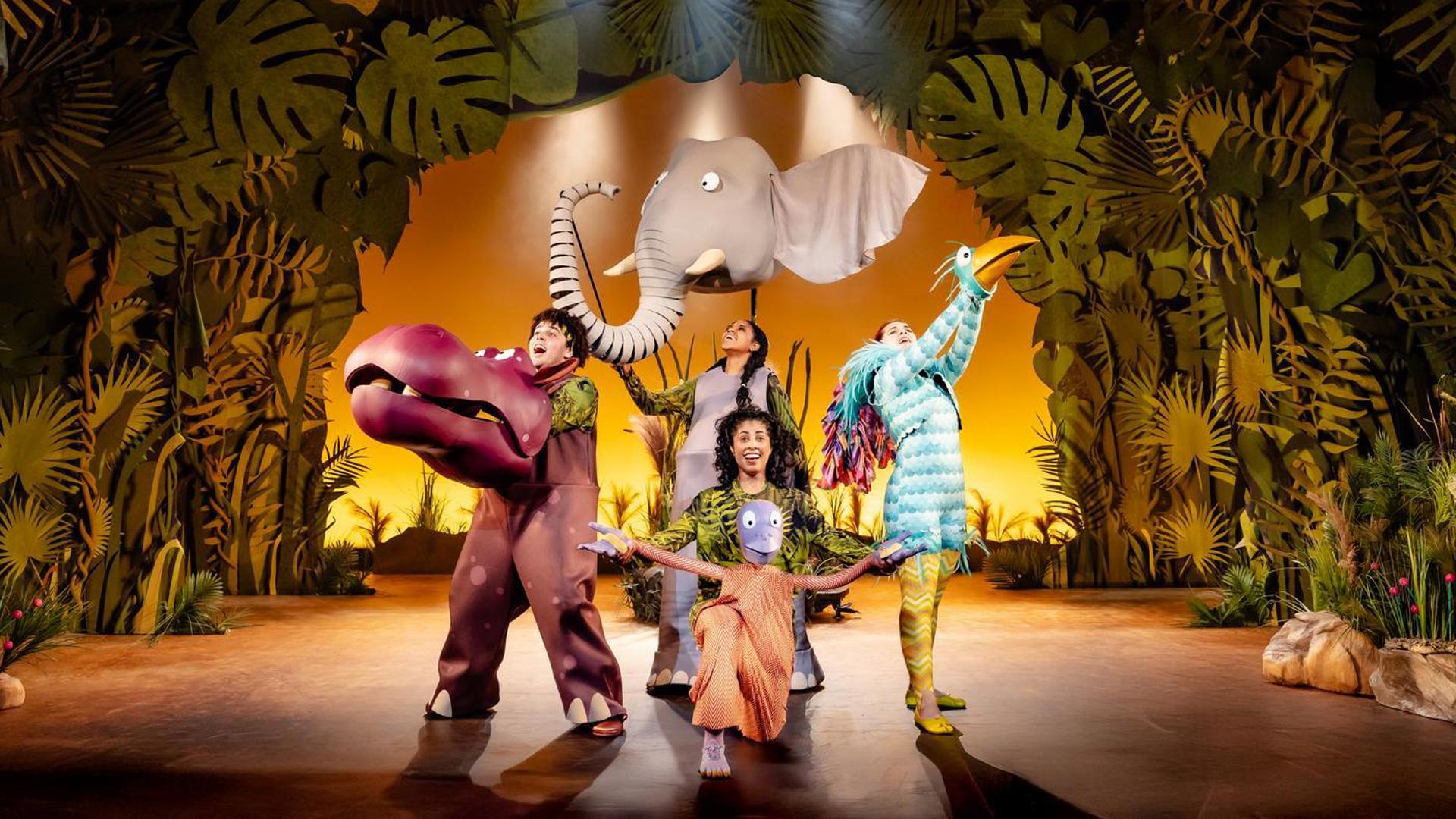 An elephant, hippo, large bird, and orangutan strike a pose while singing.