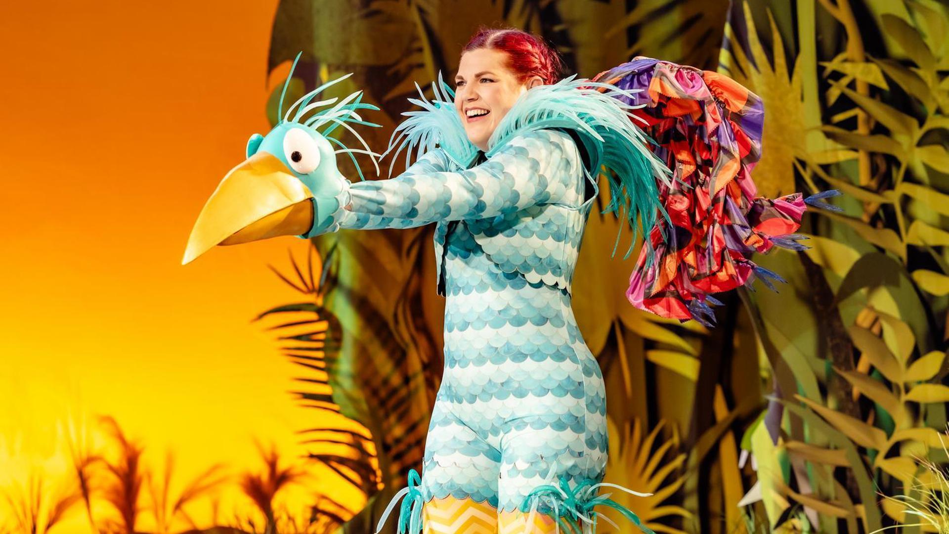 A large blue bird smiling.