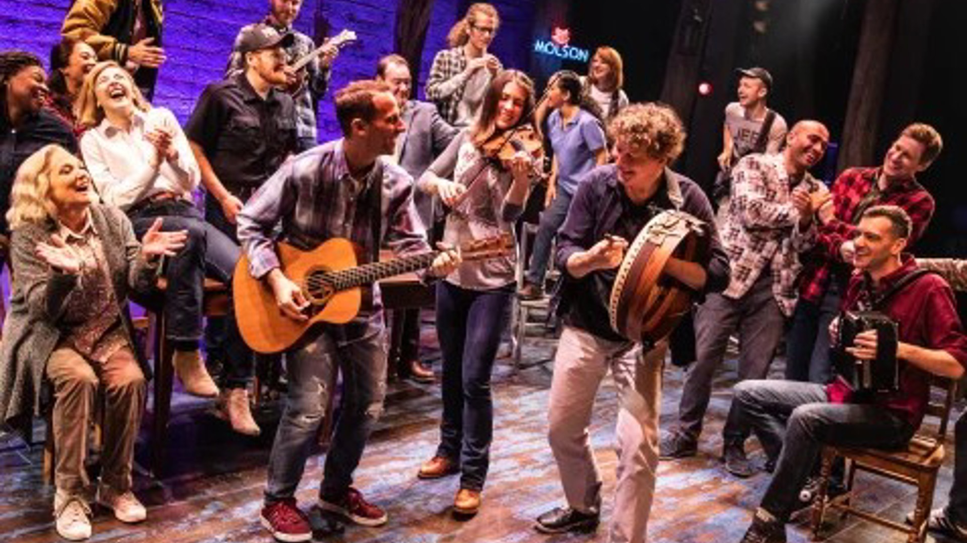 Come From Away cast on stage performing