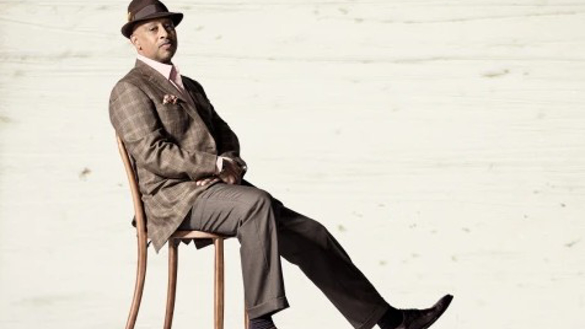 Ruben Santiago Hudson sitting in a chair for the production of Lackawanna Blues