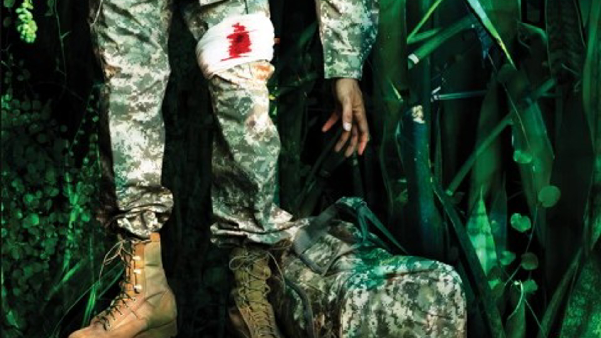 Elliot A Soldier in fatigues picking up a cacky duffle bag