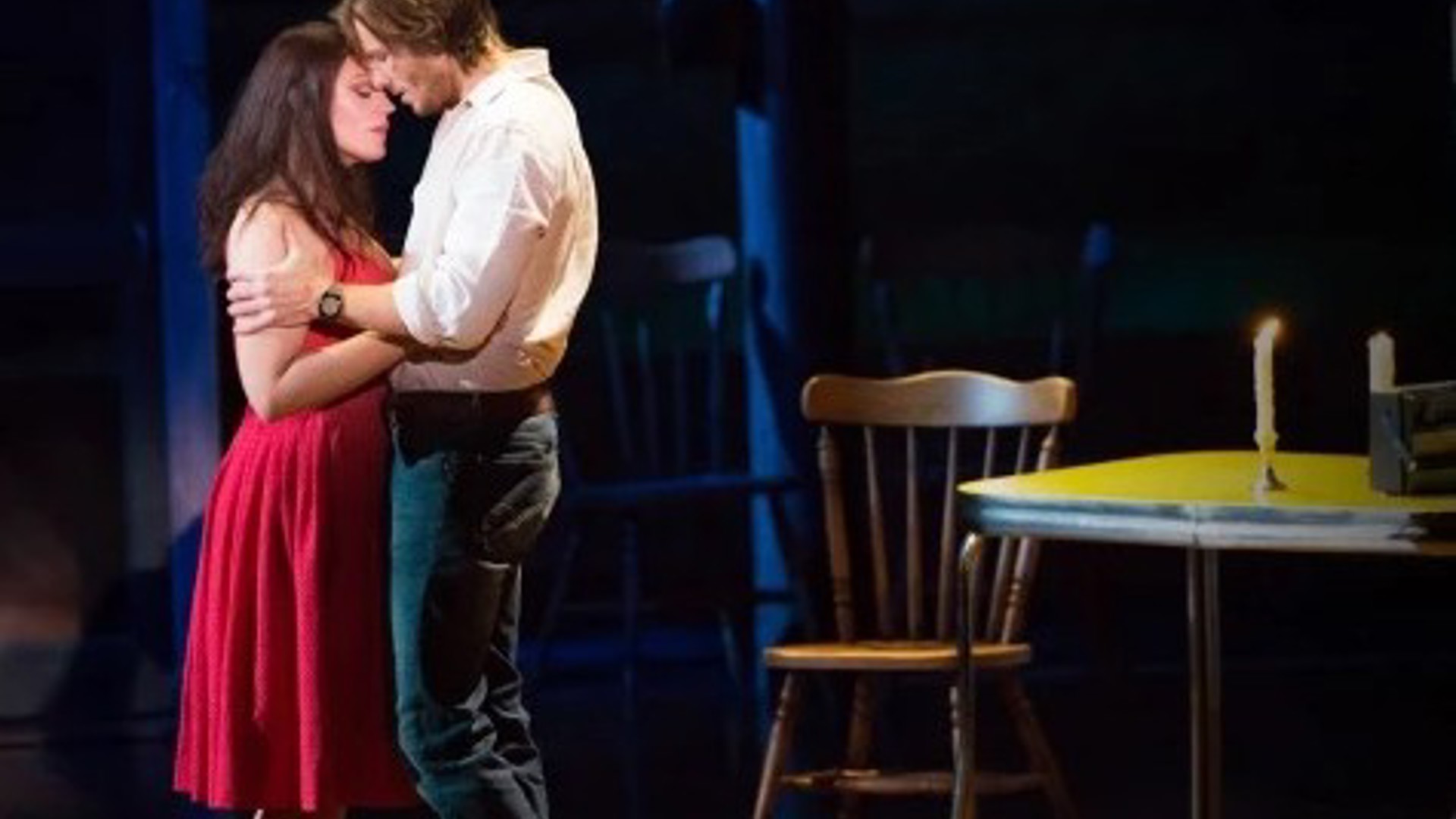 couple standing together romantically on stage at the Ahmanson Theatre