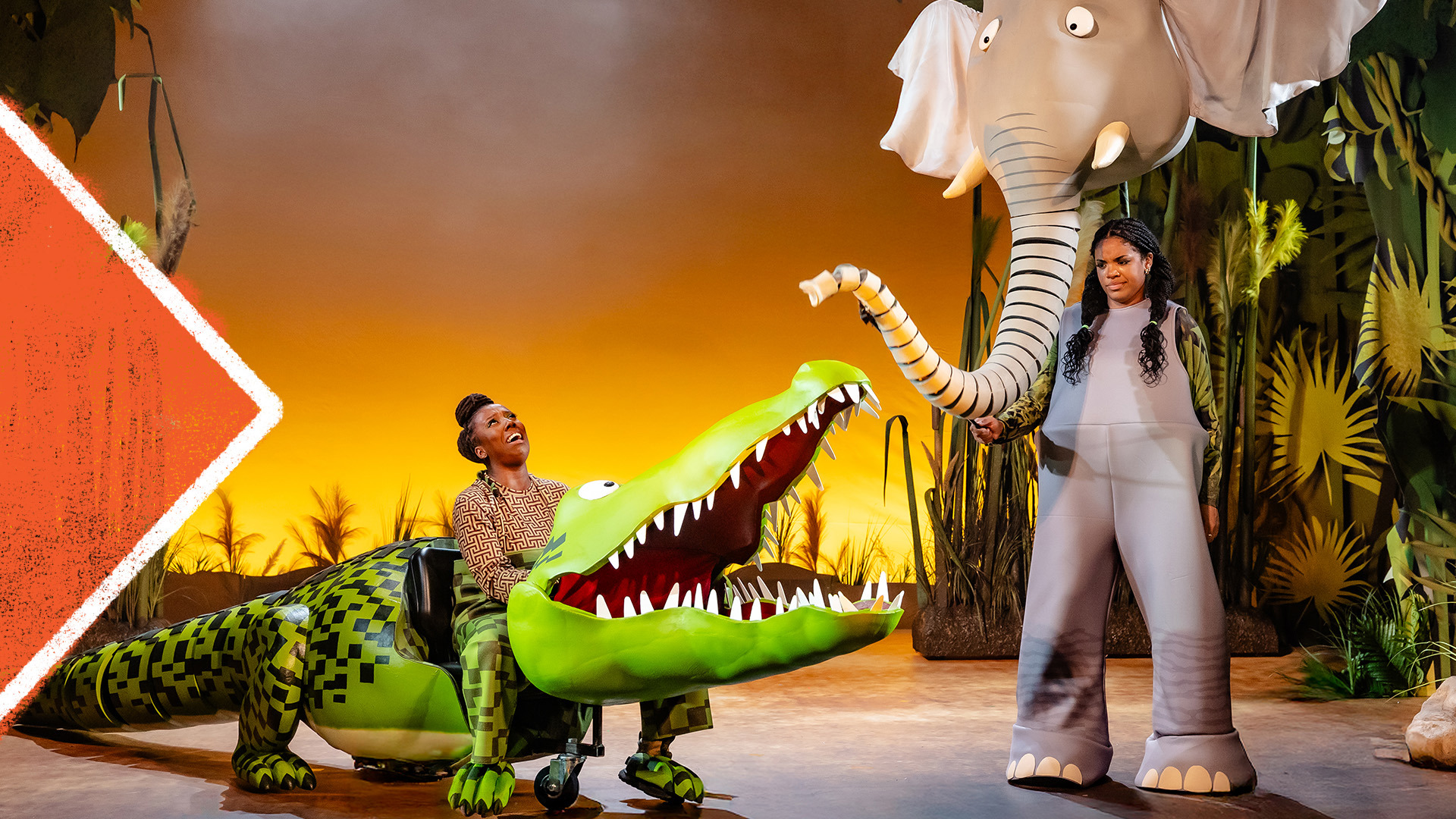 An crocodile opens it's mouth towards an elephant. 