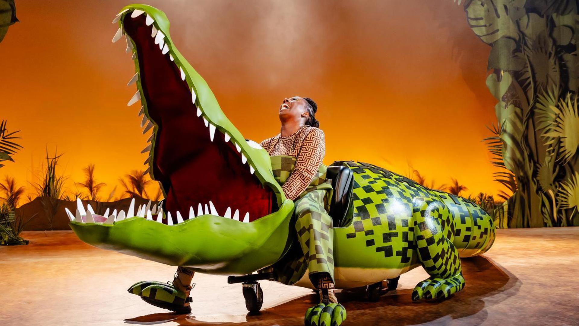 The Enormous Crocodile laughs with his jaws wide open.