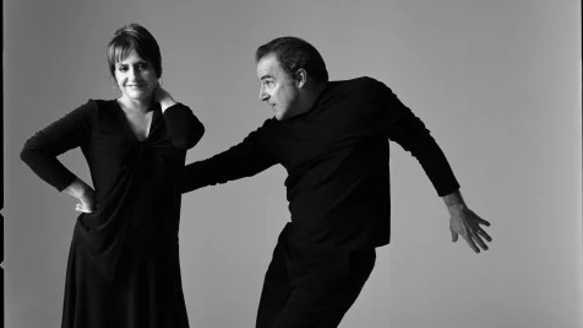 Patti Lupone and Mandy Patinkin both standing dressed in black