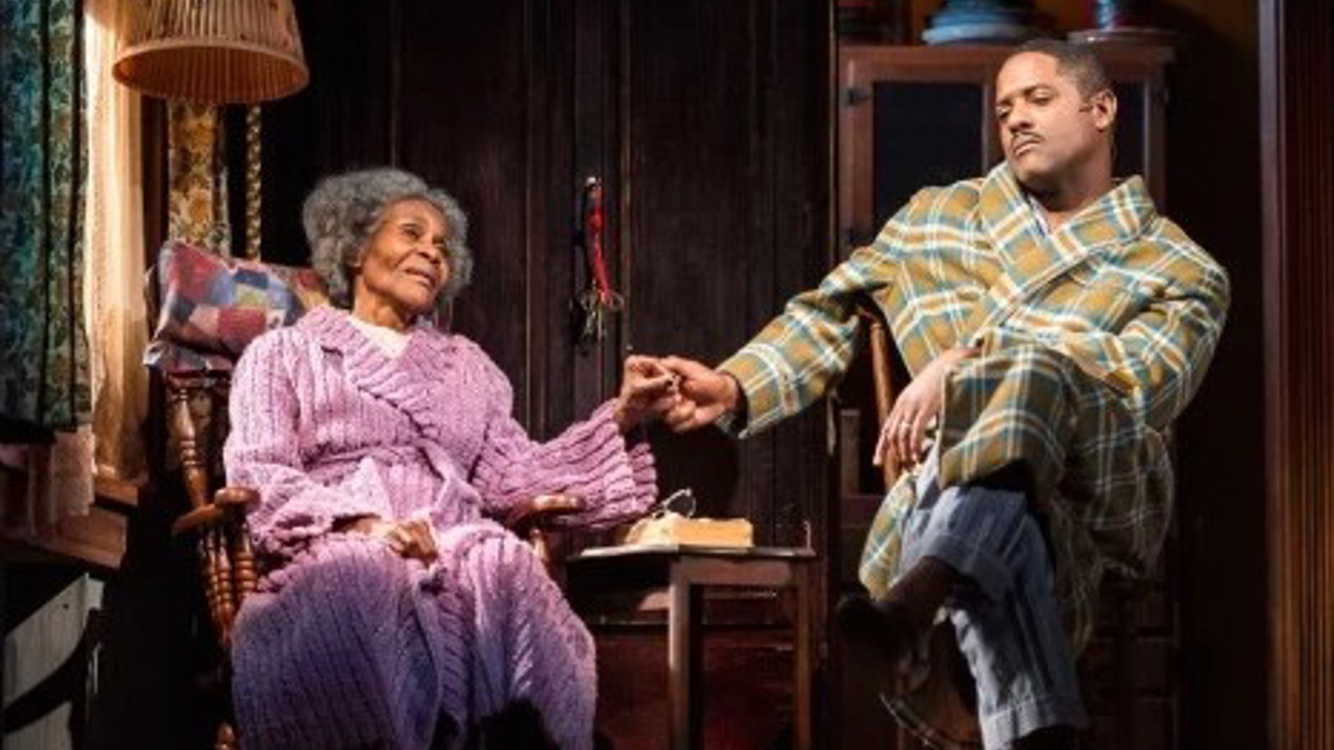 Cicely Tyson and Blair Underwood sitting in a living room holding hands in a Broadway play