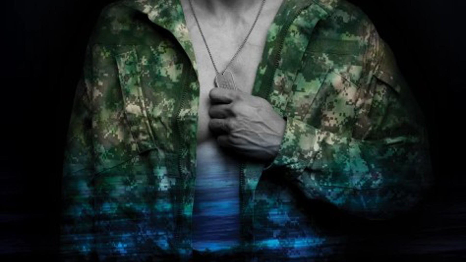 male torso with his hand holding the dog tags around his neck