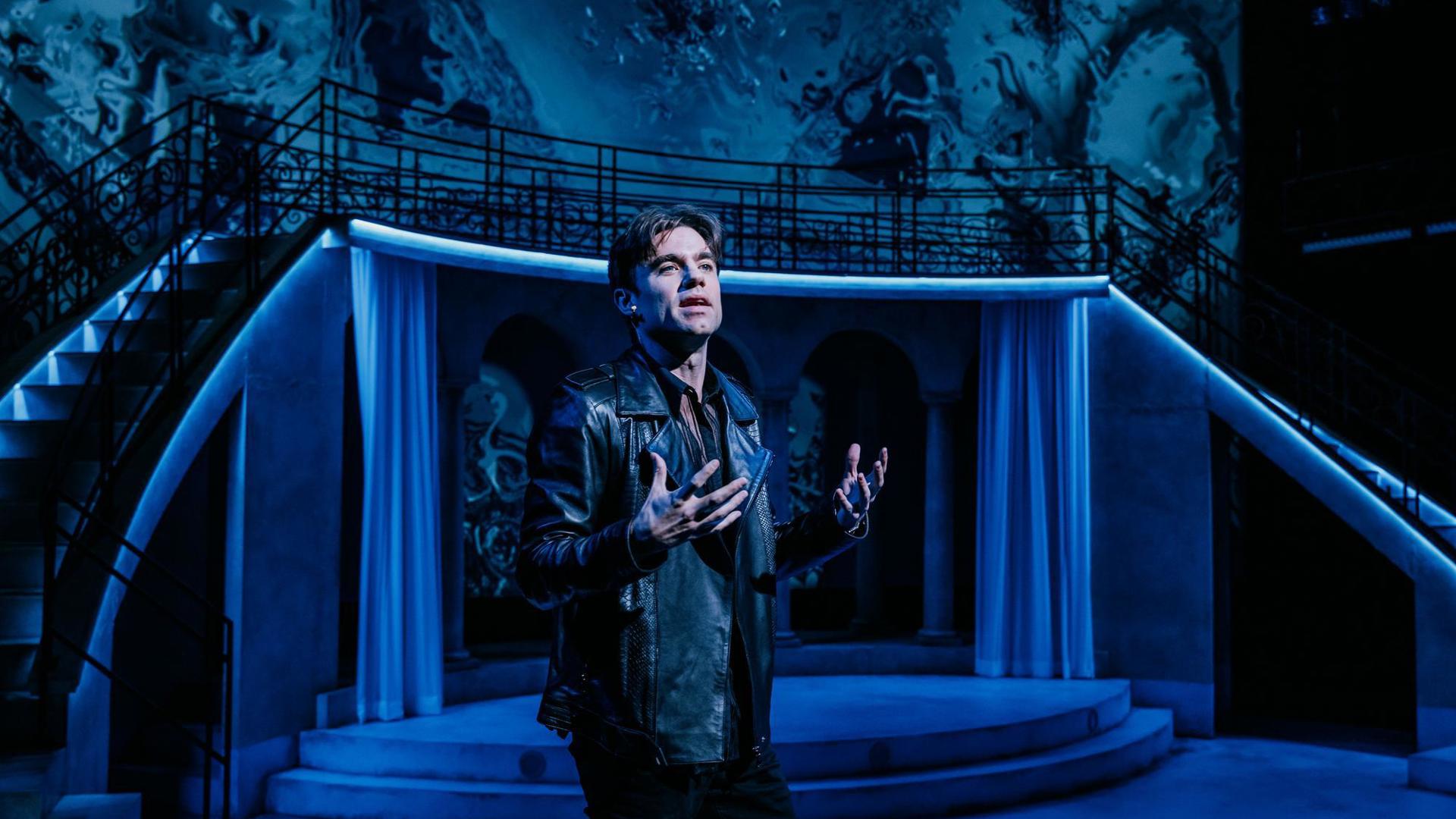 An actor speaks toward the audience.