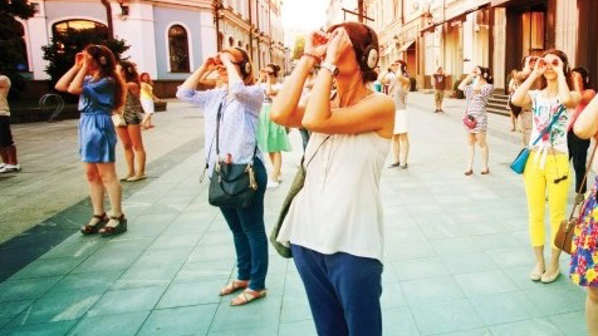 people staggered on a boardwalk in LA looking at outdoor art