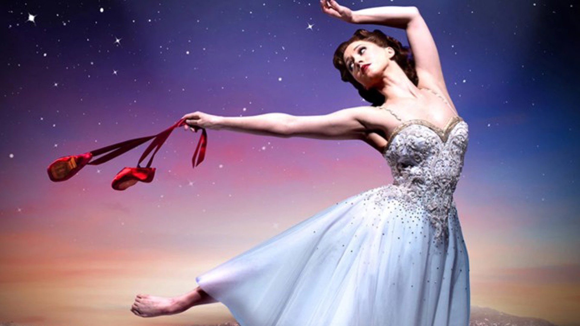 A Ballerina holding Red Shoes dancing outdoors in Los Angeles