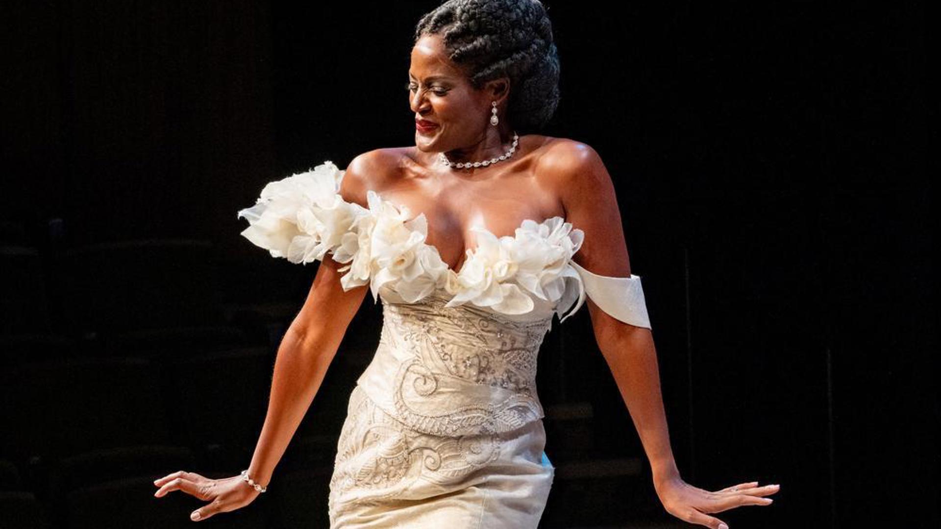 A performer shows off an extravagant wedding gown.