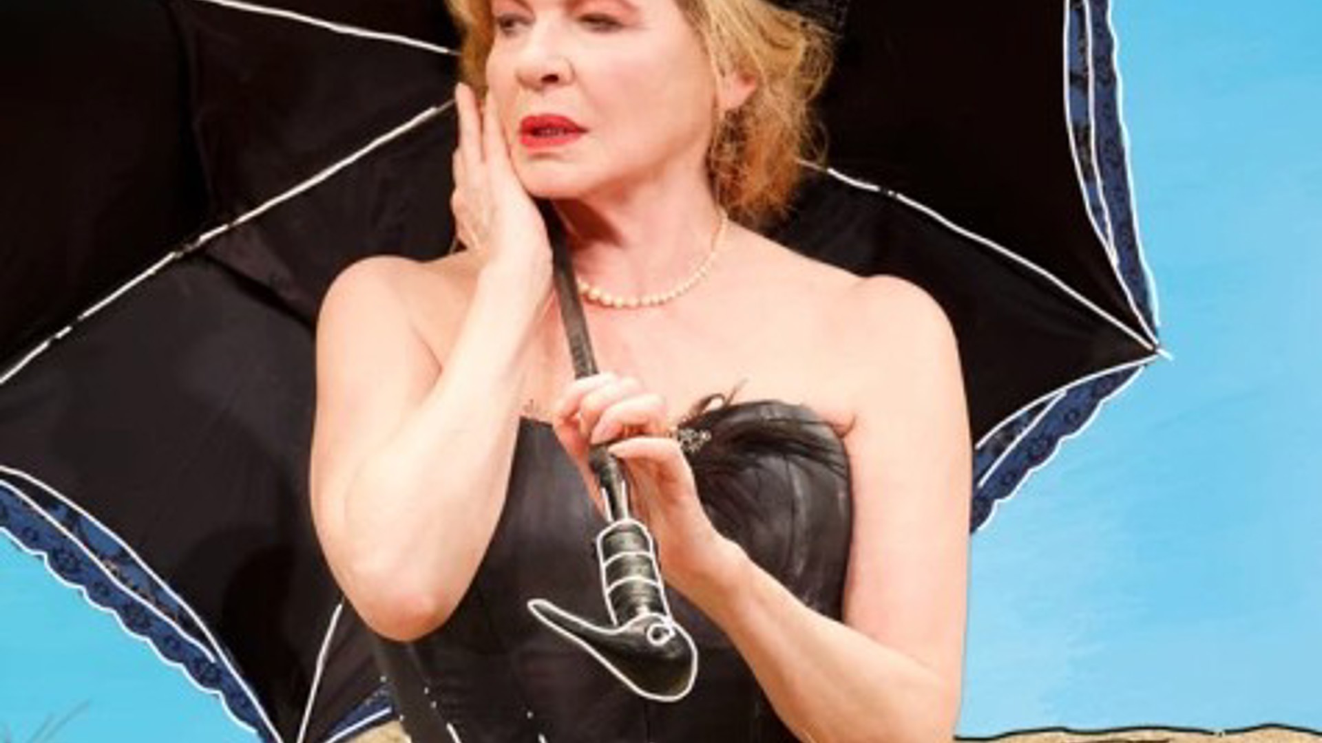 Dianne Wiest holding an umbrella in a production of Happy Days